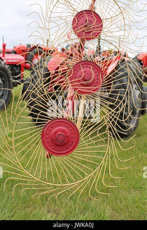 Vintage hay tedder attached to tractor at an agricultural show in Devon. Stock Photo