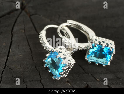 jewelry Earrings on black wood background, copy-space Stock Photo