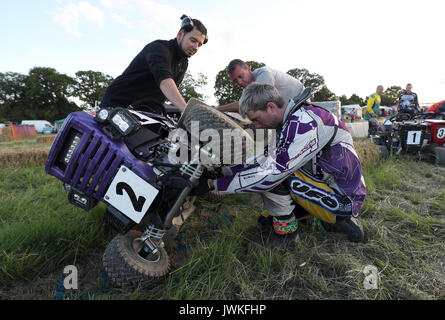 A team check their lawn mower before the beginning of the British Lawn Mower Racing Association 12 hour endurance race at Five Oaks near to Billingshurst in West Sussex. Stock Photo