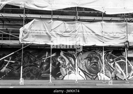 Building Graffiti Artwork, Scaffolding, Street Art Black and White Image, Person Cartoon Character Painted, Fixing, Workers Platform, Closed Off Stock Photo