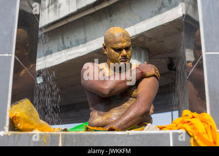 A Hindu man covers his skin with sandalwood powder after having a ritual bath during the Thaipusam Hindu festival at Batu Caves temple in Kuala Lumpur.  Thaipusam, a celebration that honors the god Murugan, is believed to bring health and prosperity to to the pilgrims willing to make the journey to the temple and give offerings. The Malaysian Thaipusam is the biggest festival of its kind in the world, with more than 1.5 million pilgrims and tourists attending. Stock Photo