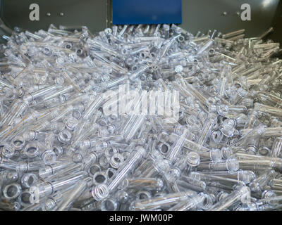 rows of empty plastic bottles at bottling plant. Production of small bottle line Stock Photo