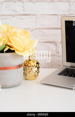 Brick Wall Product Display. Yellow Roses Mock Up. Styled Stock Photography. Golden pineapple and laptop on white desk. Fashion femininity workspace, S Stock Photo