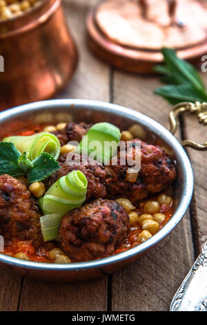 roasted lamb kofte with tomato sauce in copper pan, close view Stock Photo