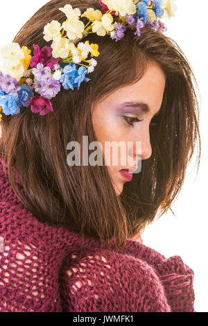 Profile of pretty teen girl with knit wool blanket and flower crown Stock Photo