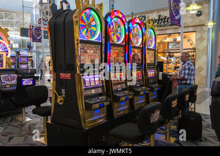 Slot machines are available for passengers immediately upon arrival at McCarran International Airport in Las Vegas, Nevada. Stock Photo