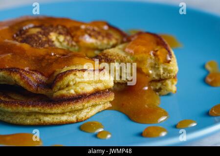 Homemade gluten free pancakes with peach jam served on sky blue plate. Close up shot Stock Photo