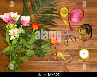 The florist desktop with working tools on wooden background Stock Photo