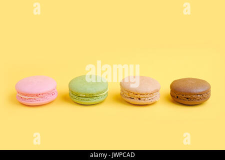 Colorful french macaroons on row Stock Photo