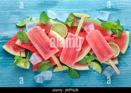 Watermelon,slices of lemon and mint leaves on blue background Stock Photo
