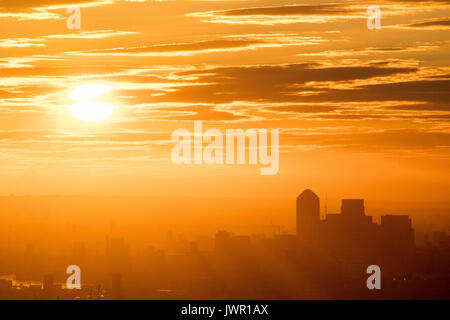 The sun rises over London as warmer weather returns to the south of England. Stock Photo