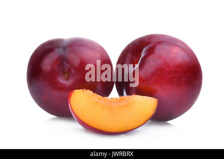 two whole and slice of red cherry plums isolated on white background Stock Photo