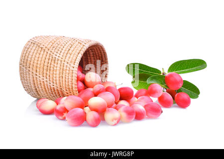 karanda or carunda tropical fruit in wooden basket with green leaves isolated on white background Stock Photo