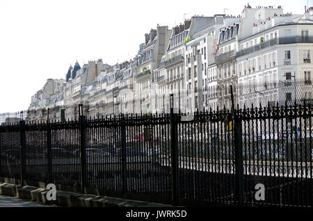 Houses on the only developed side of, Rue de Rome, Paris France, over the fence of the, Square de Batignolles, Stock Photo