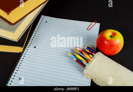 back to school concept isolated on black background Blank Notebook, Pencil, Pen, Ruler and Scissors on Wooden Background Stock Photo