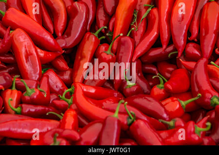 A table is filled with red chilli peppers for sale at a market in Istanbul Stock Photo