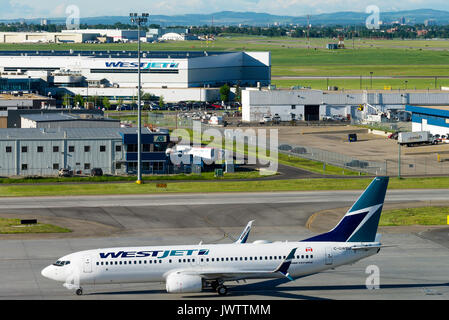 Westjet Airline Boeing 737-7CT(w) Airliner C-GWBU Taxiing at Calgary International Airport Alberta Canada Stock Photo