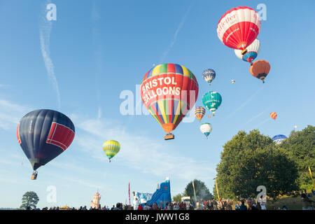 Ashton Court, Bristol, UK. 13 August 2017. The third successful mass ascent sees 111 hot air balloons launch from this year’s Bristol International Balloon Fiesta. After high winds on Saturday evening, the weather was much improved to almost perfect hot air ballooning conditions which allowed a spectacular mass ascent. The skies were filled with lots of beautiful coloured hot air balloons including a number of special shapes like the minion balloon. Credit: Neil Cordell/Alamy Live News Stock Photo
