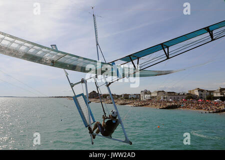 Bognor Regis, UK. 13th August, 2017. A participant tries to fly as far as possible in a hand made flying machine off the end of Bognor Resgis pier during the International Bognor Birdman competition at Bognor Regis, West Sussex, UK Sunday August 13, 2017. A hot and sunny afternoon with a gentle breeze provided the perfect weather conditions for the annual event. Photograph : Credit: Luke MacGregor/Alamy Live News Stock Photo