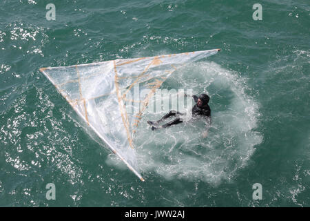 Bognor Regis, UK. 13th August, 2017. A participant lands in the water after trying to fly as far as possible in a hand made flying machine off the end of Bognor Resgis pier during the International Bognor Birdman competition at Bognor Regis, West Sussex, UK Sunday August 13, 2017. A hot and sunny afternoon with a gentle breeze provided the perfect weather conditions for the annual event. Photograph : Credit: Luke MacGregor/Alamy Live News Stock Photo