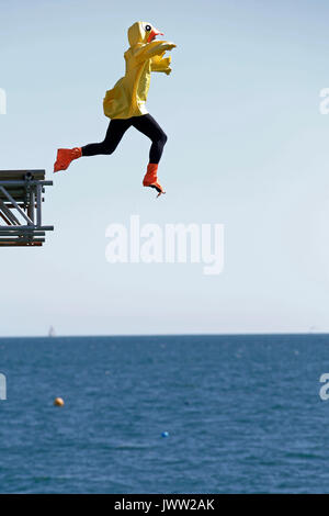 Bognor Regis, UK. 13th August, 2017. A participant in costume tries to fly as far as possible in a hand made flying machine off the end of Bognor Resgis pier during the International Bognor Birdman competition at Bognor Regis, West Sussex, UK Sunday August 13, 2017. A hot and sunny afternoon with a gentle breeze provided the perfect weather conditions for the annual event. Photograph : Credit: Luke MacGregor/Alamy Live News Stock Photo