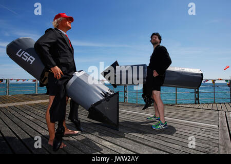 Bognor Regis, UK. 13th August, 2017. Participants dressed as Donald Trump and Kim Jong Un with nuclear war heads prepare to fly as far as possible in a hand made flying machine off the end of Bognor Resgis pier during the International Bognor Birdman competition at Bognor Regis, West Sussex, UK Sunday August 13, 2017. A hot and sunny afternoon with a gentle breeze provided the perfect weather conditions for the annual event. Photograph : Credit: Luke MacGregor/Alamy Live News Stock Photo