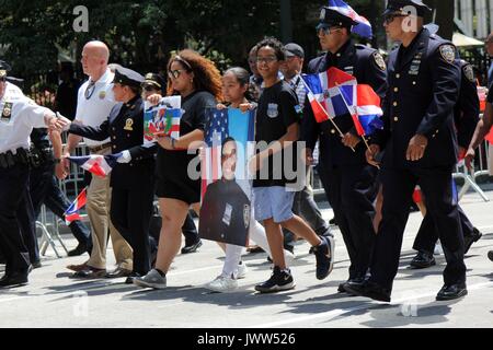 New York, NY, US. 13th. Aug, 2017. This year’s 35th. annual Dominican Day Parade in midtown Manhattan honored NYPD Officer Miosotis Familia, who was killed in the line of duty in the Bronx last month . The thousands who gathered to display Dominican pride witnessed the city honor the slain officer with a posthumous lifetime service award. There is an estimated 700,000 plus citizens from the Caribbean island of the Dominican Republic living in the New York-area. © G. Ronald Lopez /DigiPixsAgain.us/Alamy Live News Stock Photo