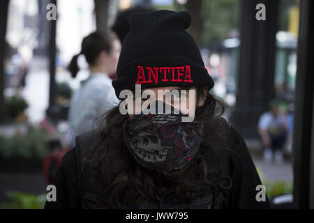 Atlanta, GA, USA. 13th Aug, 2017. Anti-Fascist protestors gather in downtown Atlanta and march along Peachtree Street, showing their support of those who demonstrated against white supremacist group in Charlottesville, VA. Rally organized by Antifa, an organization nationally that fights fascism.Pictured: Antifa member, wearing mask Credit: Robin Rayne Nelson/ZUMA Wire/Alamy Live News Stock Photo
