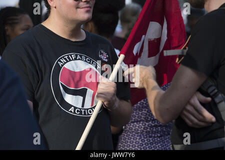 Atlanta, GA, USA. 13th Aug, 2017. Anti-Fascist protestors gather in downtown Atlanta and march along Peachtree Street, showing their support of those who demonstrated against white supremacist group in Charlottesville, VA. Rally organized by Antifa, an organization nationally that fights fascism.Pictured: antifascist member in conversation Credit: Robin Rayne Nelson/ZUMA Wire/Alamy Live News Stock Photo