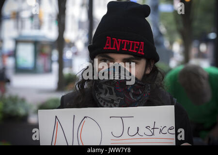 Atlanta, GA, USA. 13th Aug, 2017. Anti-Fascist protestors gather in downtown Atlanta and march along Peachtree Street, showing their support of those who demonstrated against white supremacist group in Charlottesville, VA. Rally organized by Antifa, an organization nationally that fights fascism.Pictured: Antifa member wears mask Credit: Robin Rayne Nelson/ZUMA Wire/Alamy Live News Stock Photo