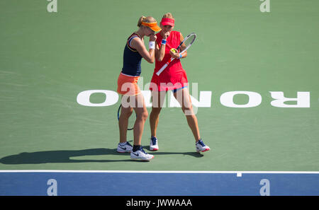 Toronto, Canada. 13th Aug, 2017. Ekaterina Makarova (L) of Russia talks to her teammate Elena Vesnina during the final match of women's doubles against Anna-Lena Groenefeld of Germany and Kveta Peschke of the Czech Republic at the 2017 Rogers Cup in Toronto, Canada, Aug. 13, 2017. Ekaterina Makarova/Elena Vesnina won 2-0 and claimed the title. Credit: Zou Zheng/Xinhua/Alamy Live News Stock Photo
