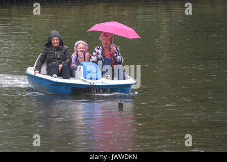 Newquay, Newquay. 14th Aug, 2017. Trenance Boating Lake; Newquay, Cornwall. 14th August, 2017. UK weather. Despite the miserable Summer weather, holidaymakers are determined to enjoy themselves in Newquay, Cornwall. Photographer Credit: Gordon Scammell/Alamy Live News Stock Photo