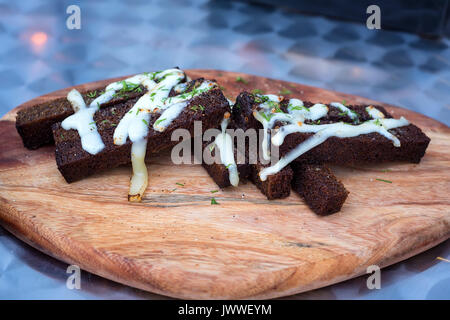 Slices of rye croutons on a wooden board Stock Photo