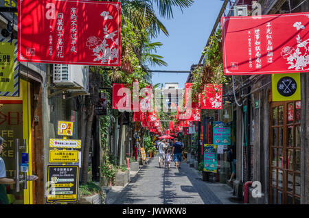 Red banners line the sides of an alleyway through Tianzifang in Shanghai, China. Stock Photo