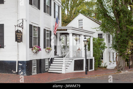 Nantucket Island - 28 September 2010: Roberts House Inn, India & Centre Sts, with a guest sitting on porch Stock Photo