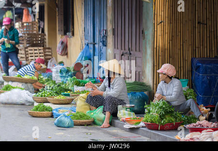 Saigon, Vietnam - June 30, 2017: Woman selling herbs on street, Saigon, Vietnam. Stock Photo