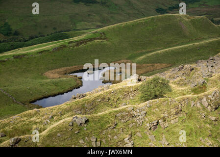 Lake below Alport Castles, A dramatic natural feature in the Alport valley, Peak District, Derbyshire, England. Stock Photo