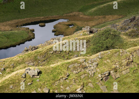 Lake below Alport Castles, A dramatic natural feature in the Alport valley, Peak District, Derbyshire, England. Stock Photo