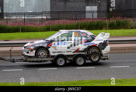 A Fraser Wilson and Craig Wallace Mitsubishi Lancer Evolution (EVO 9) Rally car being towed along the Kingsway West dual carriageway in Dundee, UK Stock Photo