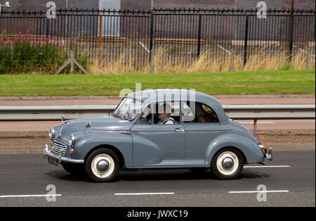 A family enjoying a day out driving in their vintage Morris 1000 car along the Kingsway West dual carriageway in Dundee, UK Stock Photo