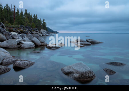 Lake Tahoe shoreline at Lake Tahoe State Park, Nevada, at early dawn on an overcast summer day. Stock Photo