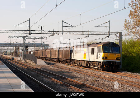 A class 92 electric locomotive number 92005 working a freight made up for vans at Cheddington on the West Coast Main Line. Stock Photo