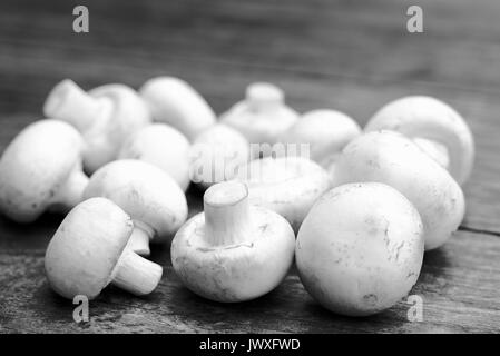 Fresh white mushrooms on a wooden gray table. Stock Photo