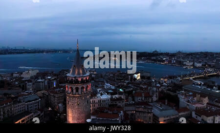 Galata Tower Aerial Urban View Photo feat. Istanbul Skyline and Cityscape with Goldenhorn Bosphorus at Night Stock Photo