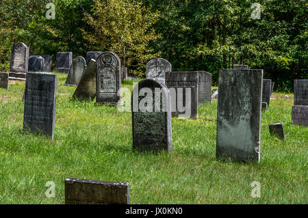 Old forgotten graveyard with gravestones from 1700 and 1800 hundreds in the forest Stock Photo