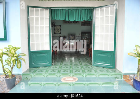 View of opened steel doors on Vietnamese style home in Lai Thieu. VIETNAM Stock Photo