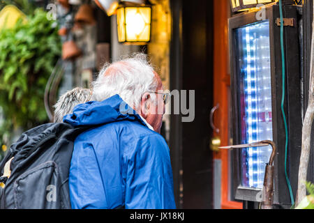 Quebec City, Canada - May 30, 2017: Lower old town street called Rue du Petit Champlain with older couple looking at menu of restaurant closeup Stock Photo