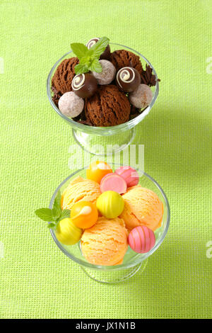 Two cups  of ice cream  with chocolate truffles and fruit-flavored pralines Stock Photo