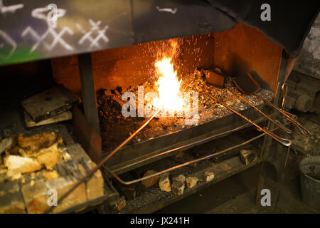 Blacksmith oven fire in workshop for metal heating Stock Photo