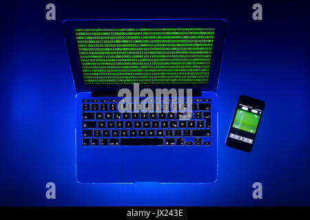 Laptop, symbolic image, cybercrime, computer crime, computer hacker, data security, smartphone tracking Stock Photo